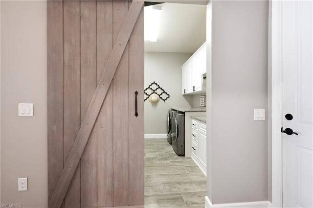 19125 Aqua Shore Dr, Estero, FL 33913 Entrance to laundry room with wood-finish barn door entry
