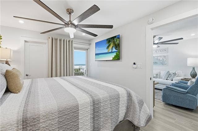 8300 Estero Blvd, #104, Fort Myers Beach, FL 33931 Ceiling fan with integrated lighting, recessed ceiling lighting, light-toned wall paint, doorway leading to a balcony, and a doorway leading to a separate living area - Virtually Edited Image