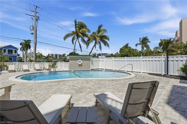 8300 Estero Blvd, #104, Fort Myers Beach, FL 33931 Freeform swimming pool with integrated spa and paver surround - Virtually Edited Image