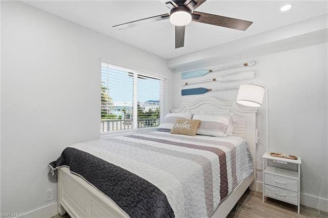 8300 Estero Blvd, #104, Fort Myers Beach, FL 33931 Recessed lighting, wood-finish ceiling fan with integrated light, white window blinds, and wood-finish flooring - Virtually Edited Image