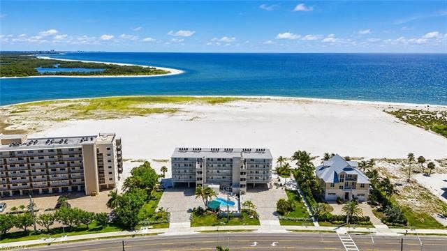8300 Estero Blvd, #104, Fort Myers Beach, FL 33931 Coastal location with direct beach access, expansive beachfront, and a private pool - Virtually Edited Image