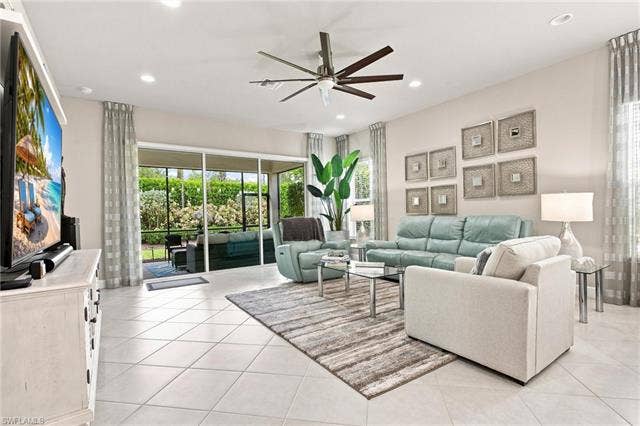 28410 Capraia Dr, Bonita Springs, FL 34135 Spacious living area featuring large format tile flooring, recessed lighting, and a modern ceiling fan