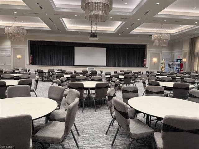 28410 Capraia Dr, Bonita Springs, FL 34135 Spacious event hall featuring a stage with dark drapery, recessed lighting, and elegant tiered chandeliers