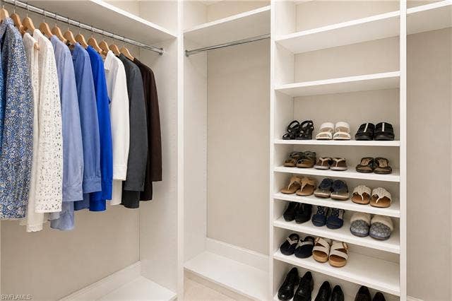 28410 Capraia Dr, Bonita Springs, FL 34135 Built-in closet system featuring multiple hanging rods and integrated shelving