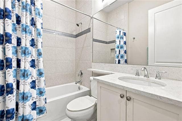 28410 Capraia Dr, Bonita Springs, FL 34135 Full vanity mirror over a single-basin sink with chrome hardware