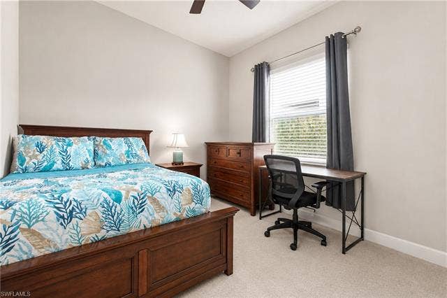 28410 Capraia Dr, Bonita Springs, FL 34135 Neutral wall paint, ceiling fan, window with blinds, and light-toned carpet flooring