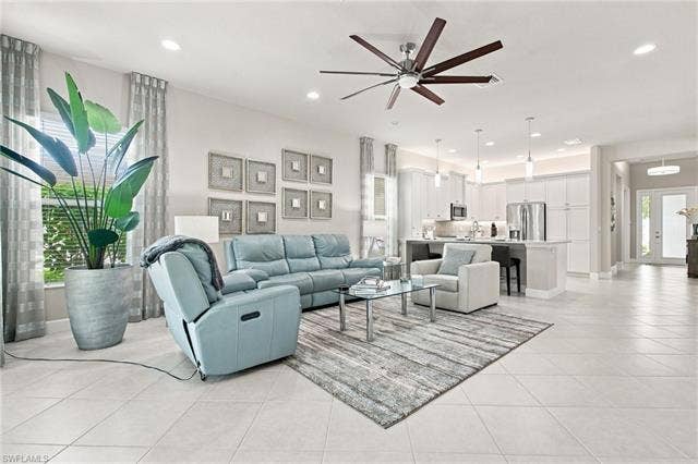 28410 Capraia Dr, Bonita Springs, FL 34135 Open-concept living area featuring large format tile flooring, recessed lighting, and a contemporary ceiling fan