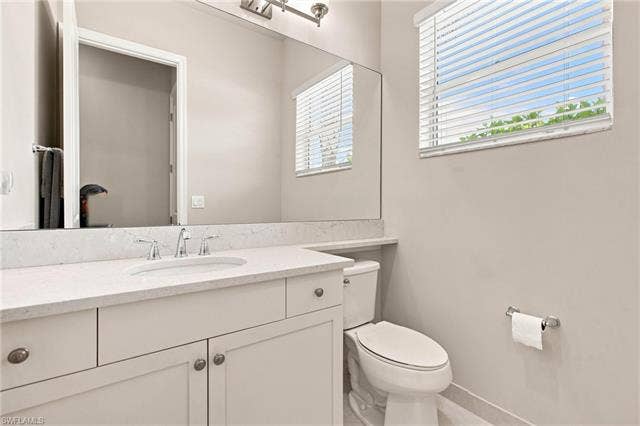 28410 Capraia Dr, Bonita Springs, FL 34135 Vanity with stone-finish countertop, undermount sink, and chrome faucet
