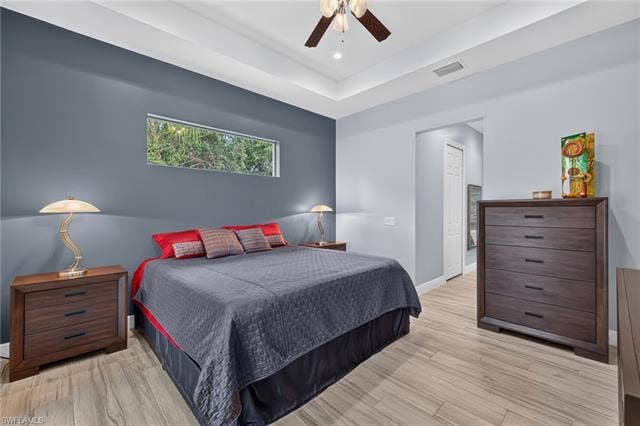 27150 Rue De Paix, Bonita Springs, FL 34135 Tray ceiling with recessed lighting and a ceiling fan, horizontal transon window