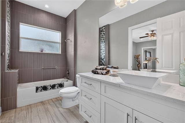 27150 Rue De Paix, Bonita Springs, FL 34135 White vanity with a rectangular vessel sink, sleek faucet, and quartz-finish countertop