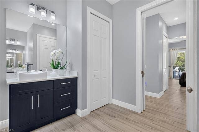 27150 Rue De Paix, Bonita Springs, FL 34135 Bathroom vanity featuring a vessel sink, dark cabinetry, and a large mirror