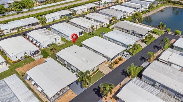 60 Palos Dr, Naples, FL 34104 Aerial view of the home and permitted 2023 TPO membrane roof.