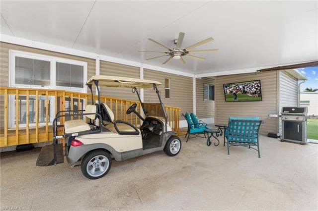 60 Palos Dr, Naples, FL 34104 The oversized carport functions as an outdoor living area. Electric golf cart included.