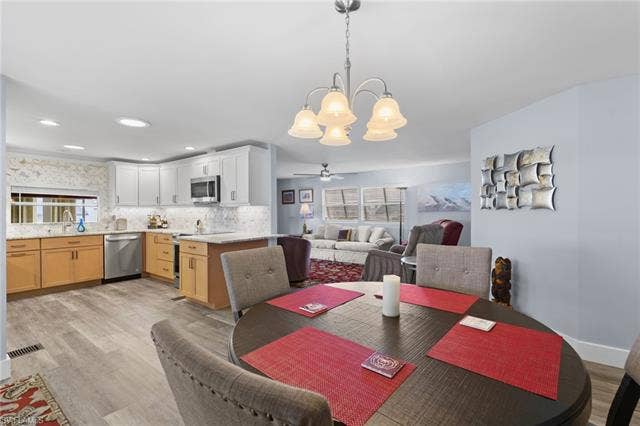 60 Palos Dr, Naples, FL 34104 Open living and dining areas flow naturally into the remodeled kitchen.