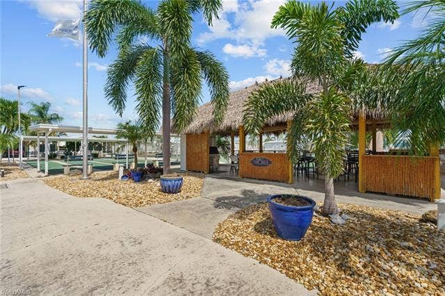 60 Palos Dr, Naples, FL 34104 Community tiki hut provides a tropical gathering place for residents.