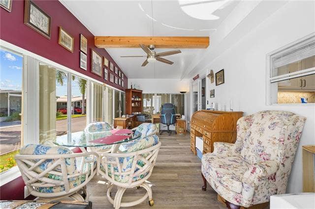 60 Palos Dr, Naples, FL 34104 Window-lined Florida room/den offers flexible space for hobbies, cards or a home office.