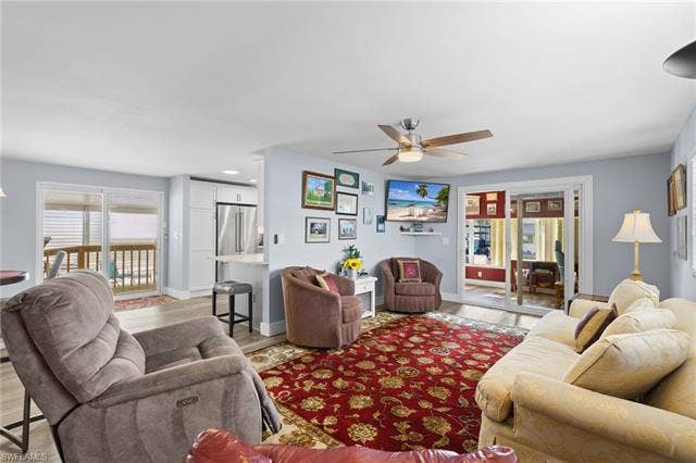 60 Palos Dr, Naples, FL 34104 Comfortable living room with direct access to the Florida room/den.