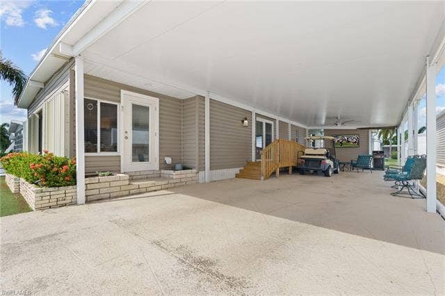 60 Palos Dr, Naples, FL 34104 Oversized covered carport provides generous parking and shaded outdoor living space.