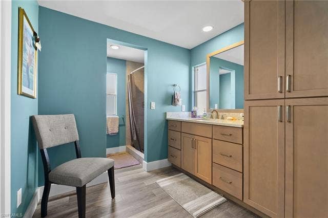 60 Palos Dr, Naples, FL 34104 Updated primary bathroom with extensive cabinetry and storage.