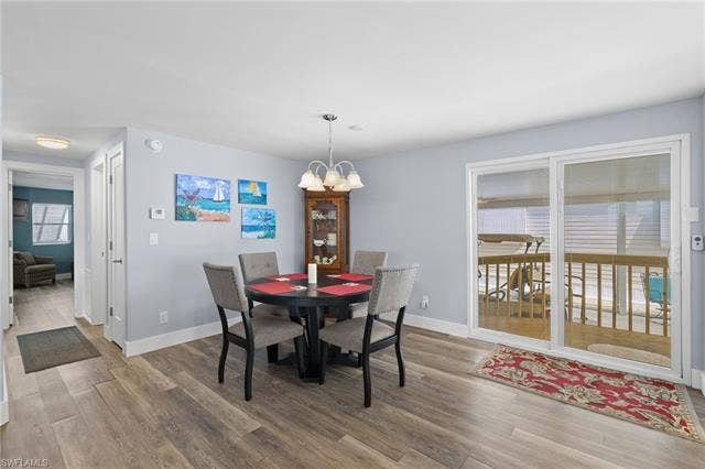 60 Palos Dr, Naples, FL 34104 Dining area with wide-plank flooring.