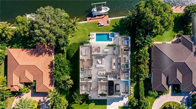 5219 S Seminole Ct, Cape Coral, FL 33904 (Rendered photo) Waterfront property featuring a private boat dock, adjacent swimming pool, and large green space