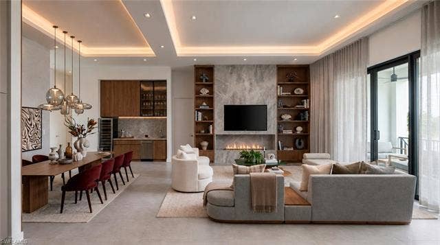 5219 S Seminole Ct, Cape Coral, FL 33904 (Rendered photo) Recessed and cove lighting, built-in shelving, a linear fireplace, a wet bar with integrated appliances, and sliding glass doors with balcony access