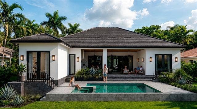 5219 S Seminole Ct, Cape Coral, FL 33904 (Rendered photo) Expansive rear exterior featuring a swimming pool, integrated spa, covered patio, and stepped hardscaping