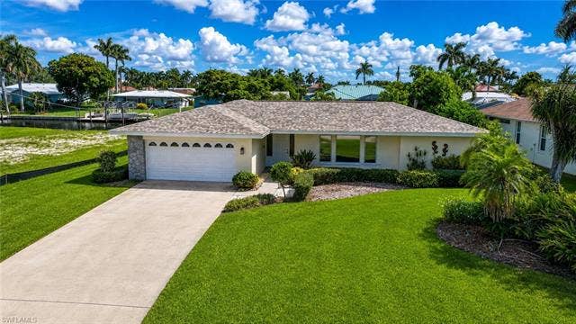 5219 S Seminole Ct, Cape Coral, FL 33904 Manicured front lawn with mature landscaping