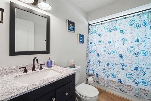 4618 Sierra Ln, Bonita Springs, FL 34134 Blue vanity with integrated sink, speckled countertop