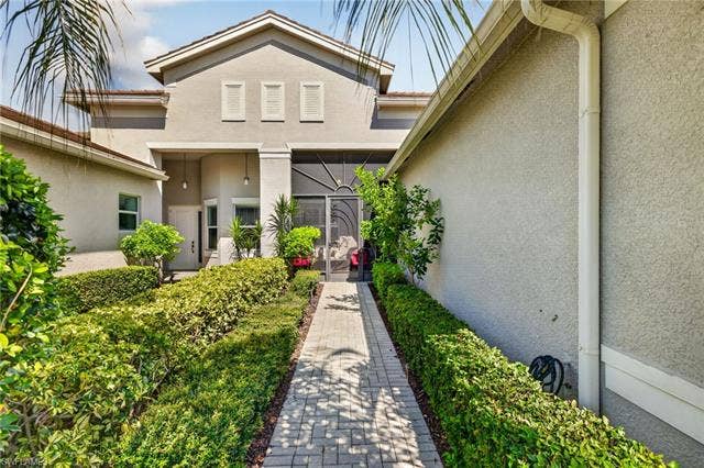 28405 Abruzzo Dr, Bonita Springs, FL 34135 Screened front porch for extra outdoor living space! Widened walkway and driveway