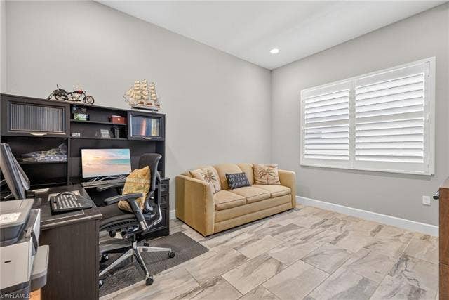 28405 Abruzzo Dr, Bonita Springs, FL 34135 Den holds a sleeper sofa, corner desk and a tv console piece, too! Note the plantation shutters here, too!