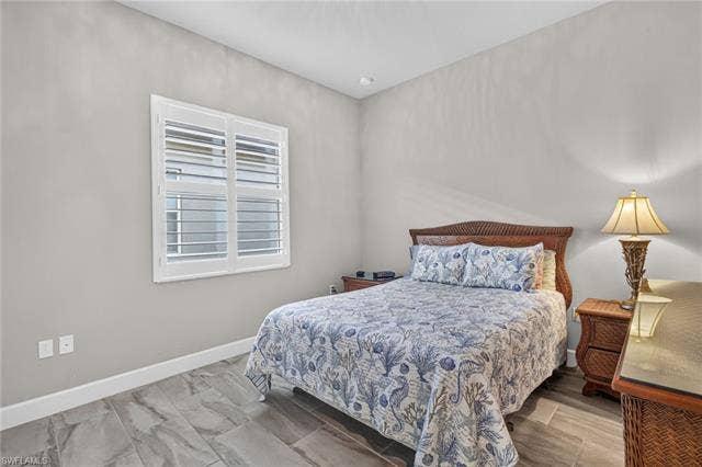 28405 Abruzzo Dr, Bonita Springs, FL 34135 Continuation of plantation shutters and beautiful plank tile flooring present! Nice sized closet here, too!
