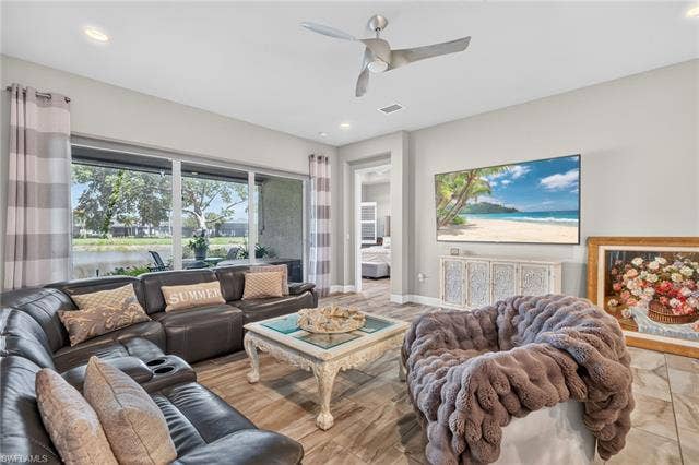 28405 Abruzzo Dr, Bonita Springs, FL 34135 Spacious great room is adjacent to primary suite; all with high impact glass and doors!