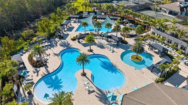 28405 Abruzzo Dr, Bonita Springs, FL 34135 Resort pool with beach entance, resistance pool, and lap pool in distance photo.