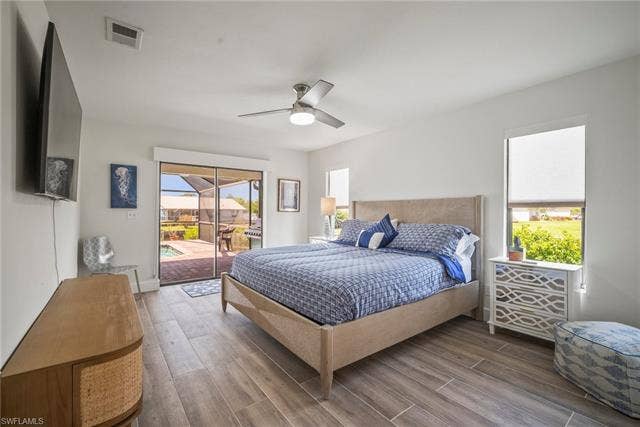 20640 Porthole Ct, Estero, FL 33928 Bedroom featuring visible vents, wood finished floors, ceiling fan, and access to exterior