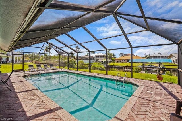 20640 Porthole Ct, Estero, FL 33928 Pool featuring a yard, a patio area, and a lanai