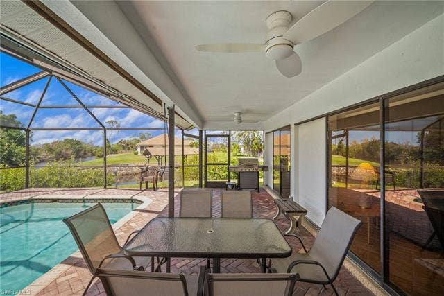 20640 Porthole Ct, Estero, FL 33928 Sunroom / solarium featuring a swimming pool, outdoor dining area, and ceiling fan