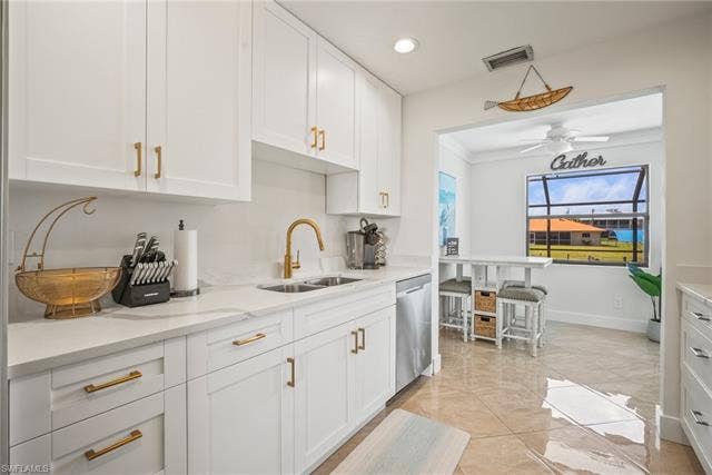 20640 Porthole Ct, Estero, FL 33928 Kitchen featuring white cabinets, dishwasher, visible vents, and a sink