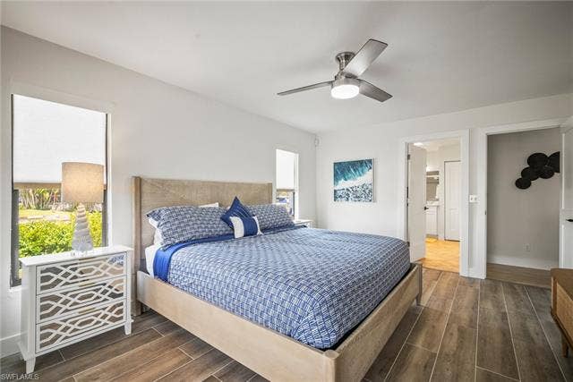 20640 Porthole Ct, Estero, FL 33928 Bedroom featuring dark wood finished floors and a ceiling fan