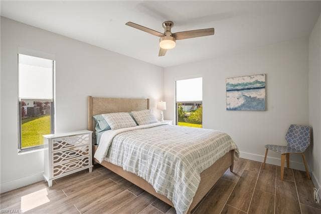 20640 Porthole Ct, Estero, FL 33928 Bedroom with ceiling fan, baseboards, and wood finished floors