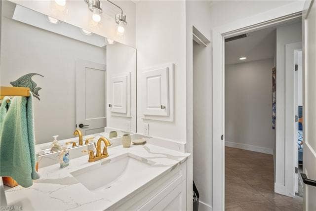 20640 Porthole Ct, Estero, FL 33928 Bathroom with baseboards, visible vents, and vanity