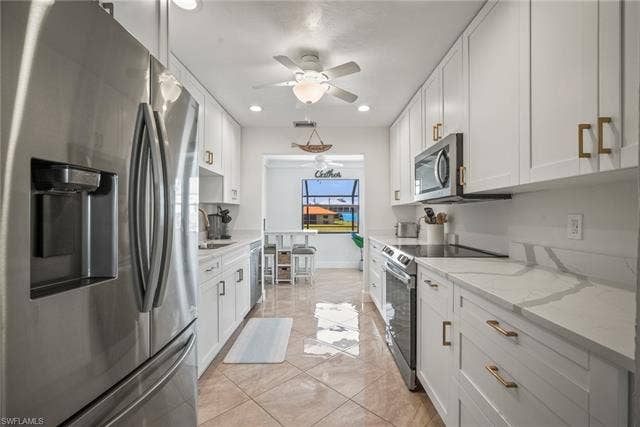 20640 Porthole Ct, Estero, FL 33928 Kitchen featuring white cabinets, a ceiling fan, stainless steel appliances, and recessed lighting