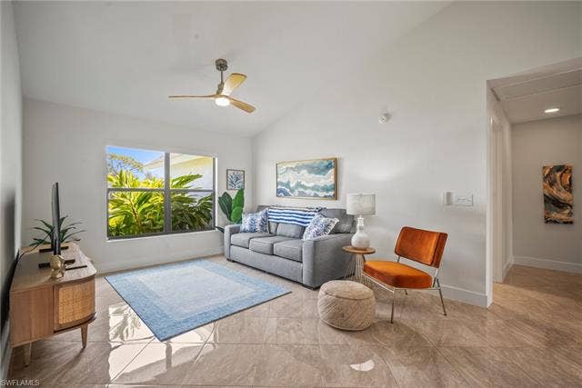 20640 Porthole Ct, Estero, FL 33928 Living area featuring attic access, vaulted ceiling, baseboards, and ceiling fan