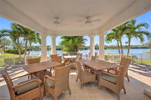 15059 Blue Marlin Ter, Bonita Springs, FL 34135 Covered patio featuring classical columns, two ceiling fans, and a tiled floor