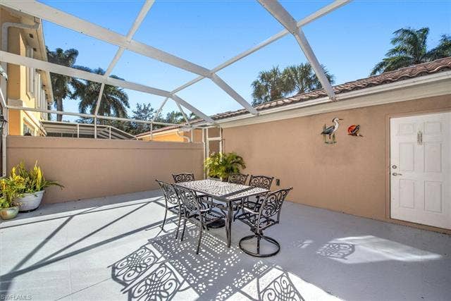 15059 Blue Marlin Ter, Bonita Springs, FL 34135 Screen-enclosed patio with a concrete surface and stucco walls