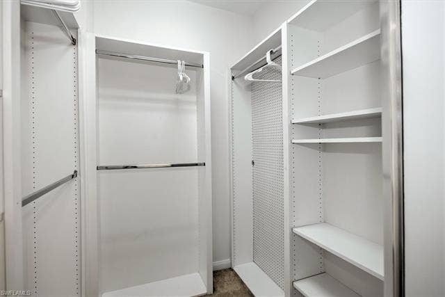 15059 Blue Marlin Ter, Bonita Springs, FL 34135 Built-in white shelving system with multiple chrome hanging rods and adjustable shelving