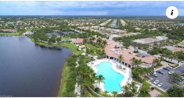 15059 Blue Marlin Ter, Bonita Springs, FL 34135 Expansive waterfront community with a large outdoor pool, extensive parking, and lush landscaping