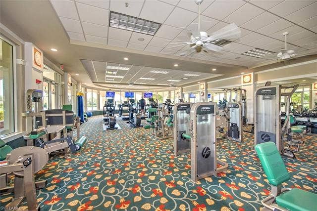 15059 Blue Marlin Ter, Bonita Springs, FL 34135 Fitness center featuring a variety of exercise equipment, ceiling fans overlooking lake , recessed lighting, and large windows