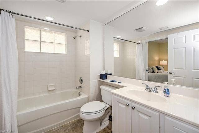 15059 Blue Marlin Ter, Bonita Springs, FL 34135 Full vanity mirror, white cabinet vanity with dual-handle faucet, integrated sink, and tile flooring