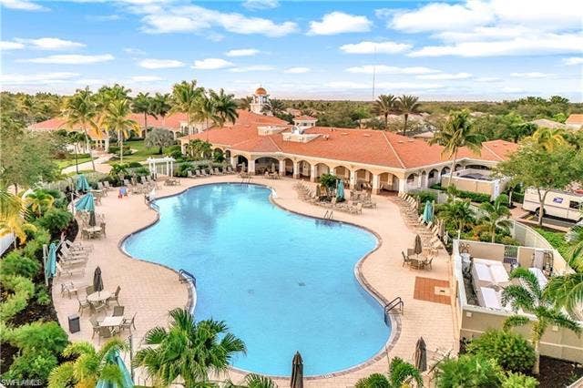 15059 Blue Marlin Ter, Bonita Springs, FL 34135 Resort pool with daily specials restaurant bar service and mature palm trees